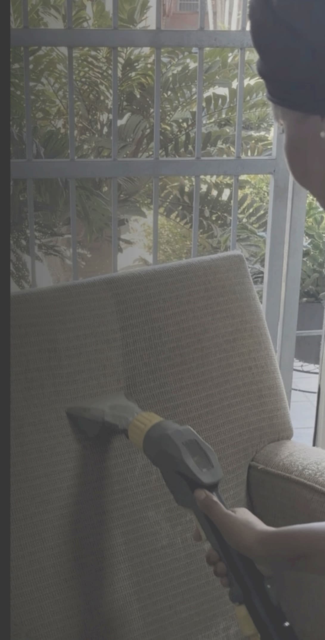 Upholstery being deep cleaned with hot-water extraction equipment